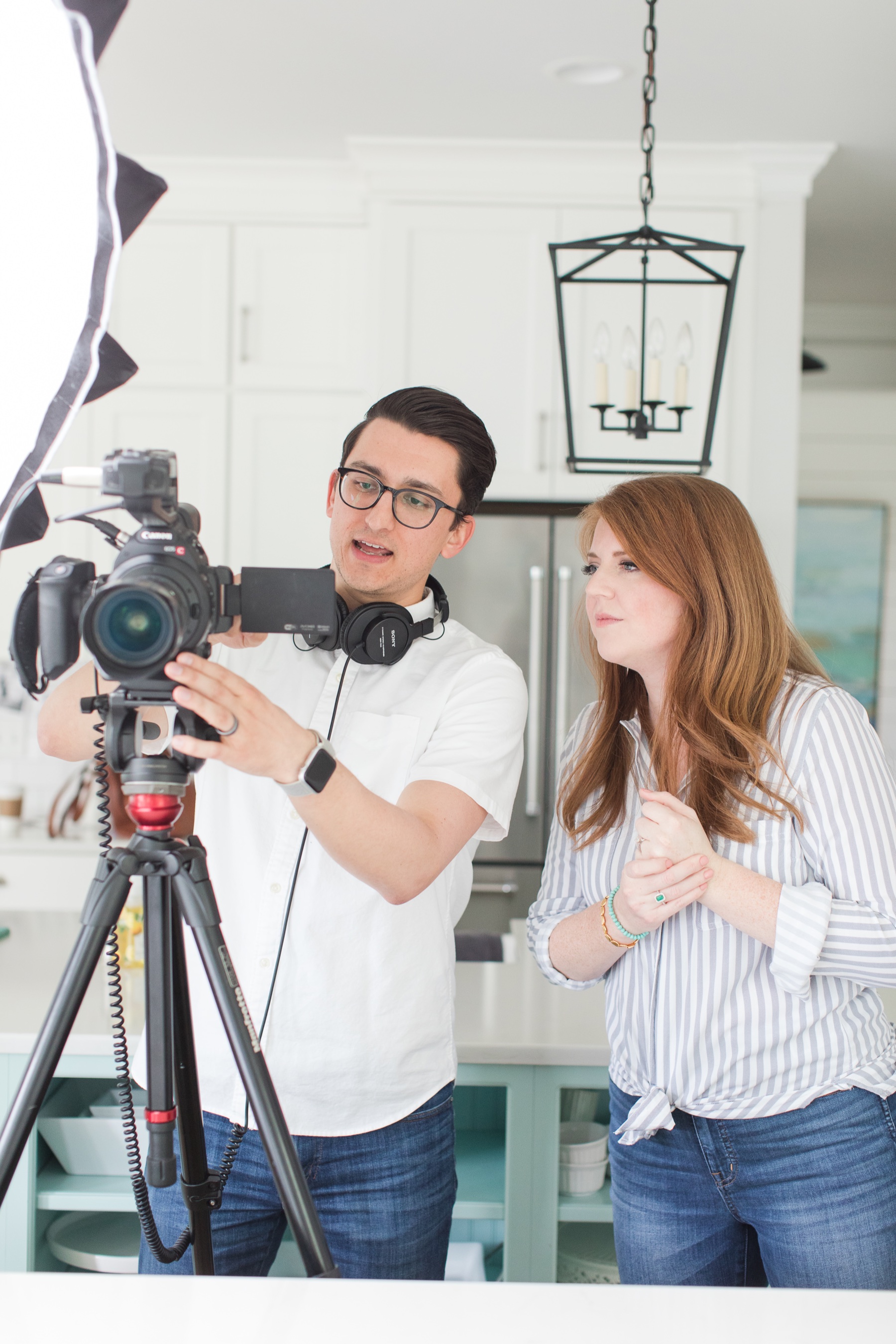 Tyler and Katelyn reviewing the camera during a filming day